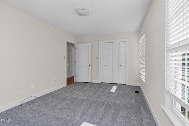 1204 Breedlove Rd, Nashville, NC 27856 - unfurnished bedroom with carpet floors, multiple windows, baseboards, and a closet