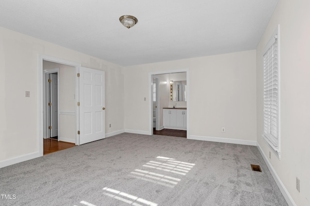 1204 Breedlove Rd, Nashville, NC 27856 - unfurnished bedroom with carpet, ensuite bath, and baseboards