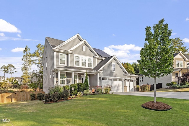 craftsman-style home featuring a garage, a front yard, and covered porch