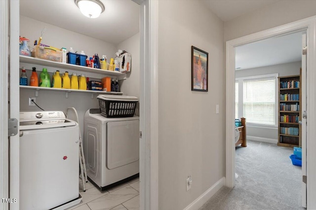 washroom with washer and dryer and light colored carpet