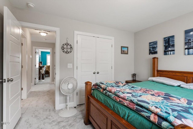 bedroom with a closet and light carpet