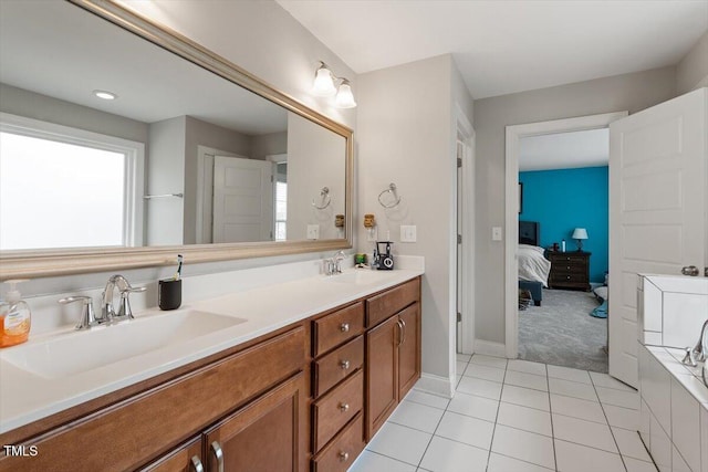 bathroom with vanity, a washtub, and tile patterned flooring