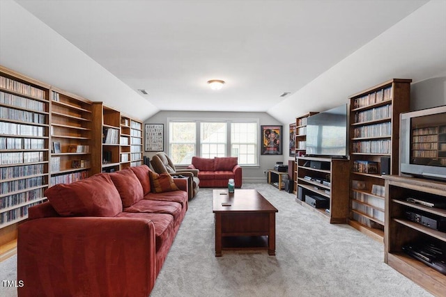 living room with light carpet and vaulted ceiling