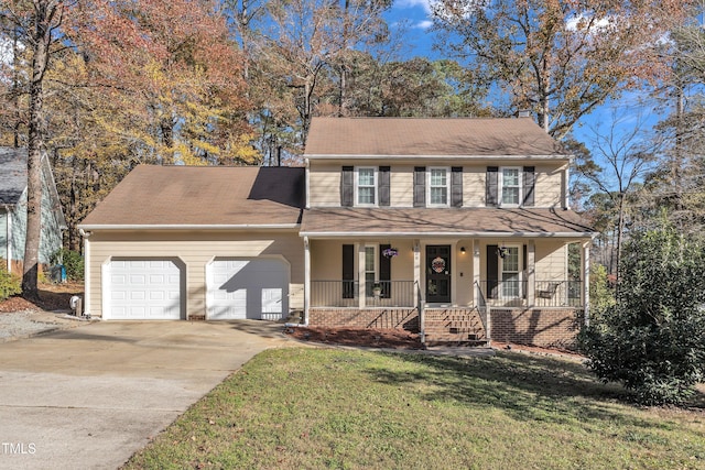 view of front of property with a porch, a garage, and a front lawn