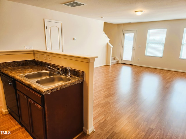 kitchen with black dishwasher, light hardwood / wood-style flooring, dark brown cabinetry, and sink