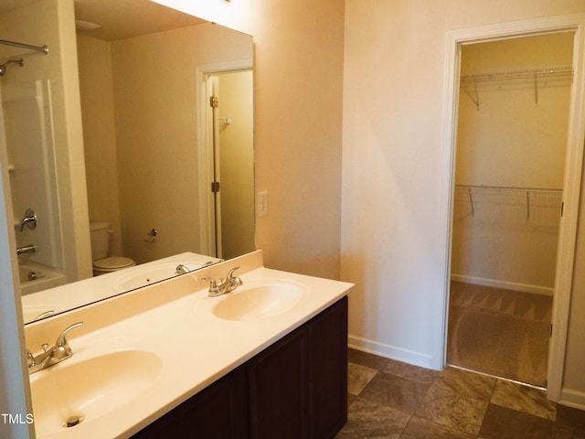 full bathroom featuring vanity, tub / shower combination, and toilet