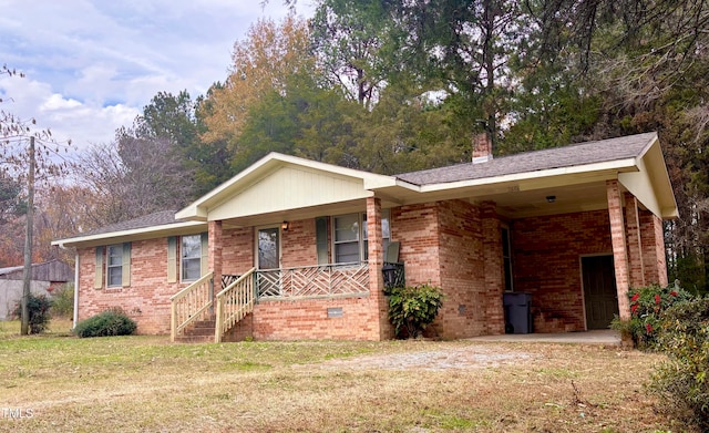 ranch-style home with a carport, covered porch, and a front lawn