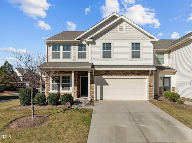 craftsman house with a front yard and a garage