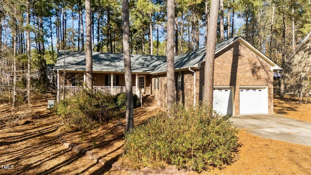 single story home with a porch and a garage