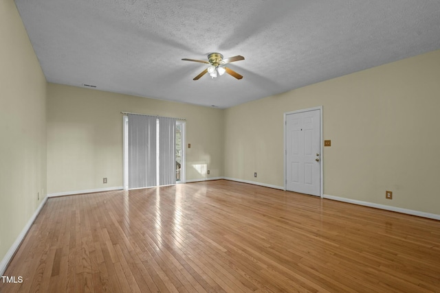 unfurnished room with ceiling fan, light hardwood / wood-style floors, and a textured ceiling