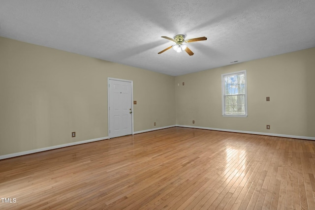 unfurnished room featuring ceiling fan, light hardwood / wood-style floors, and a textured ceiling