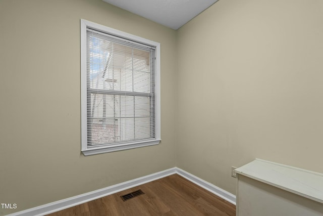 spare room with dark wood-type flooring