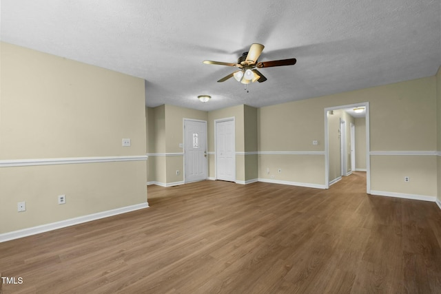 spare room with wood-type flooring, a textured ceiling, and ceiling fan