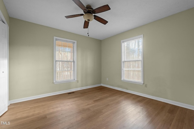 unfurnished room with ceiling fan and light hardwood / wood-style floors