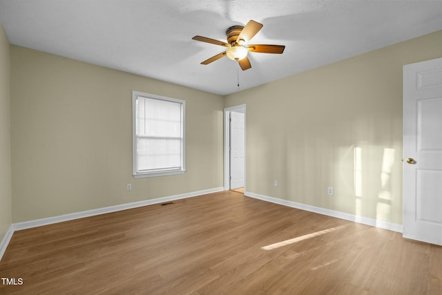 empty room with ceiling fan and wood-type flooring