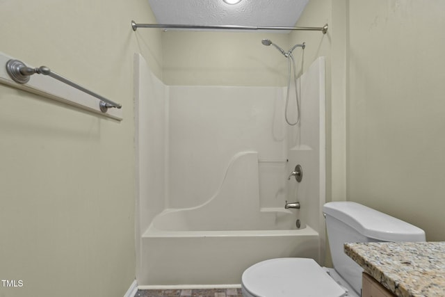 full bathroom featuring vanity, toilet, a textured ceiling, and bathtub / shower combination