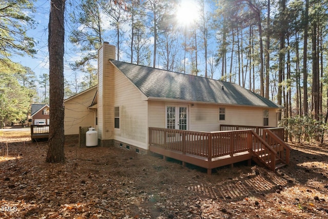 rear view of house featuring a wooden deck