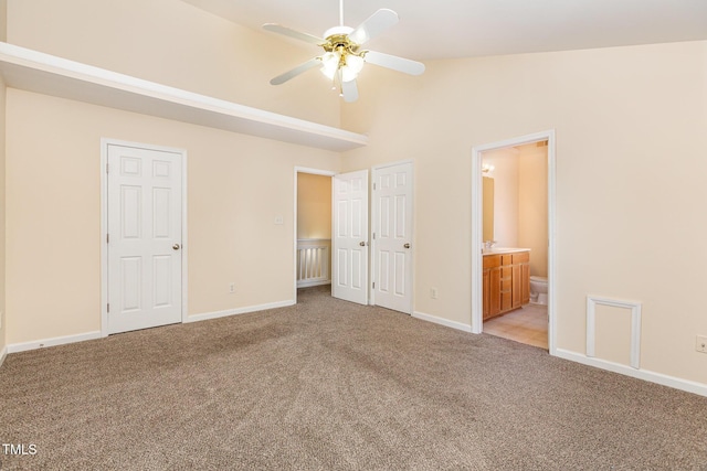 2124 Star Sapphire Dr, Raleigh, NC 27610 - unfurnished bedroom featuring light colored carpet, baseboards, connected bathroom, and high vaulted ceiling