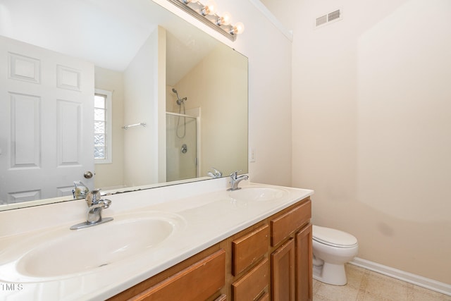 bathroom featuring tile patterned floors, vanity, an enclosed shower, and toilet