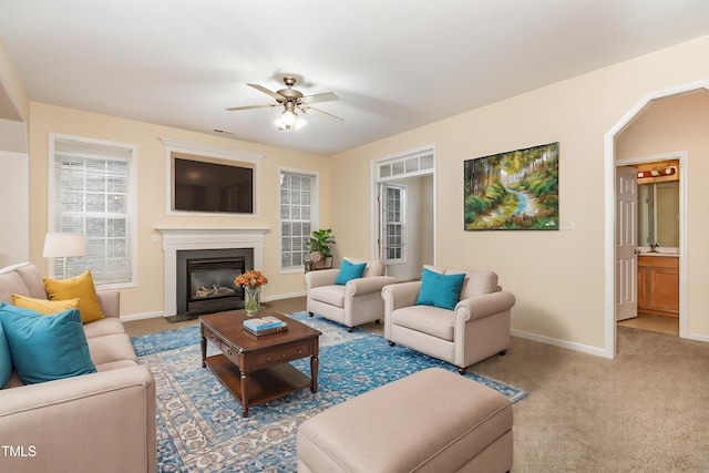 living room featuring ceiling fan and carpet