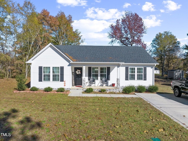 ranch-style home with a porch and a front yard