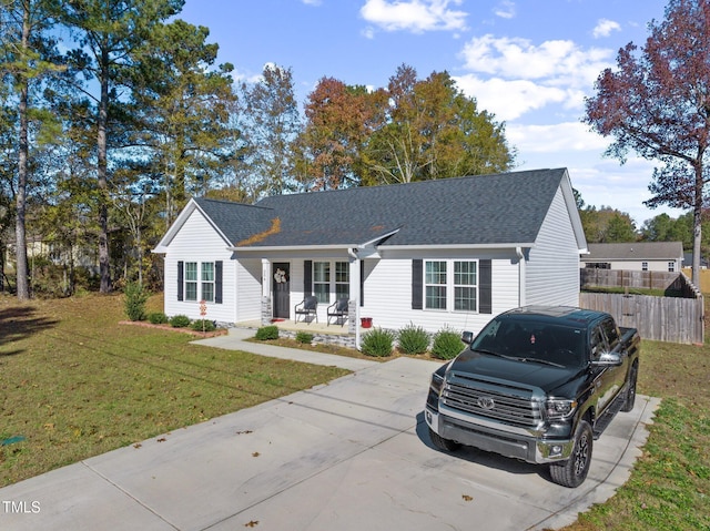 ranch-style home with covered porch and a front yard