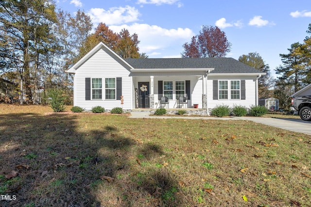 ranch-style home with covered porch and a front yard