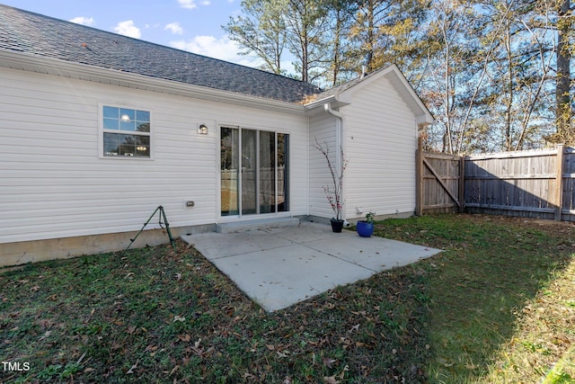 back of property featuring a lawn and a patio area