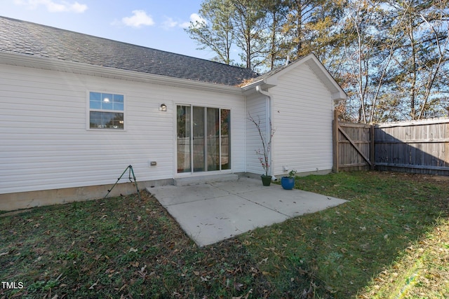 rear view of property with a patio area and a lawn