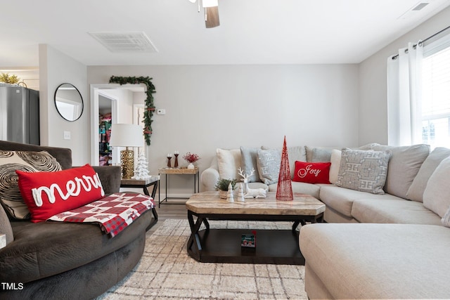 living room featuring hardwood / wood-style flooring and ceiling fan