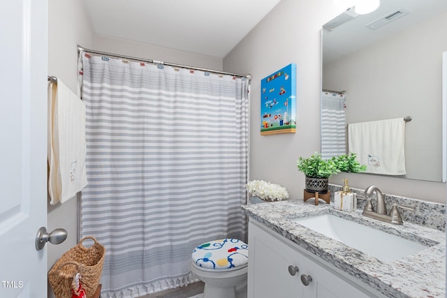 bathroom featuring vanity and toilet