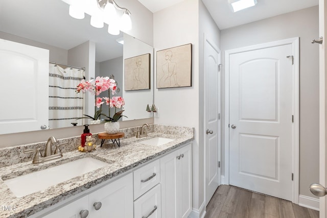 bathroom with a skylight, vanity, and hardwood / wood-style flooring