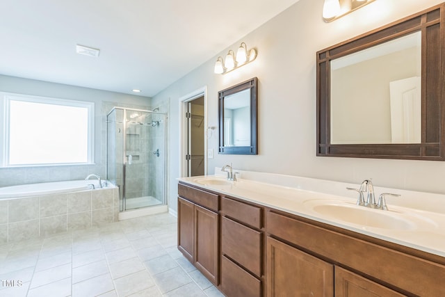 bathroom with tile patterned flooring, vanity, and separate shower and tub