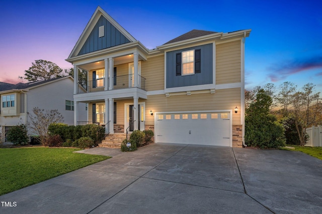 craftsman-style home featuring a yard, a balcony, and a garage