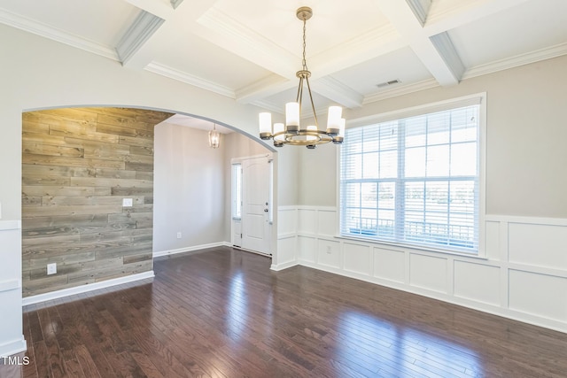 spare room featuring dark hardwood / wood-style flooring, ornamental molding, and coffered ceiling