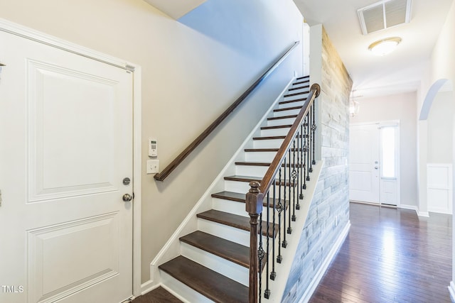 staircase with hardwood / wood-style floors