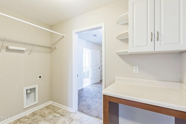 laundry room with electric dryer hookup and cabinets