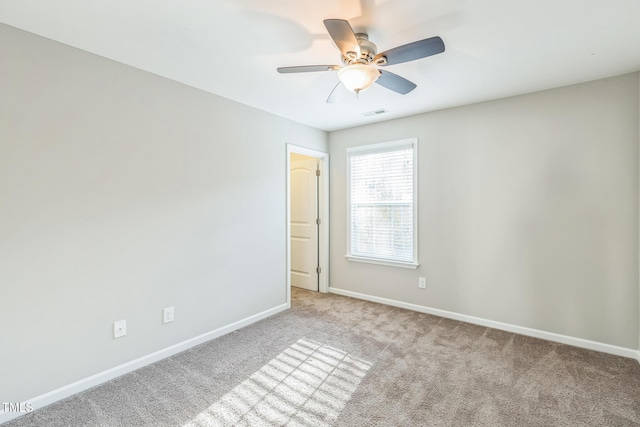 carpeted empty room featuring ceiling fan