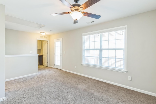 carpeted empty room featuring ceiling fan