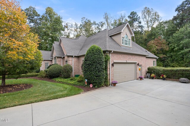 view of front of house with a front yard and a garage