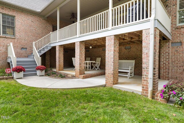 back of property with a patio, ceiling fan, and a lawn