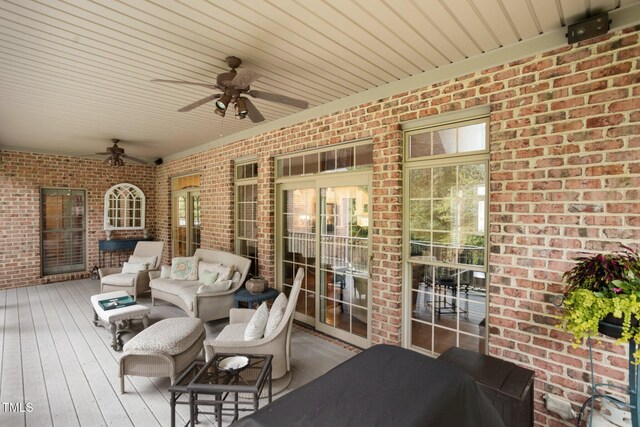 wooden terrace with ceiling fan and an outdoor hangout area