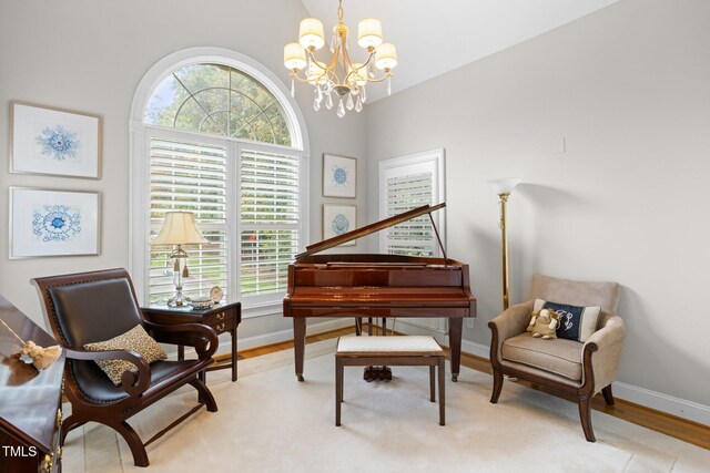 sitting room featuring light wood-type flooring and an inviting chandelier