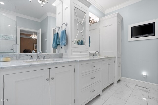 bathroom featuring an inviting chandelier, vanity, and ornamental molding