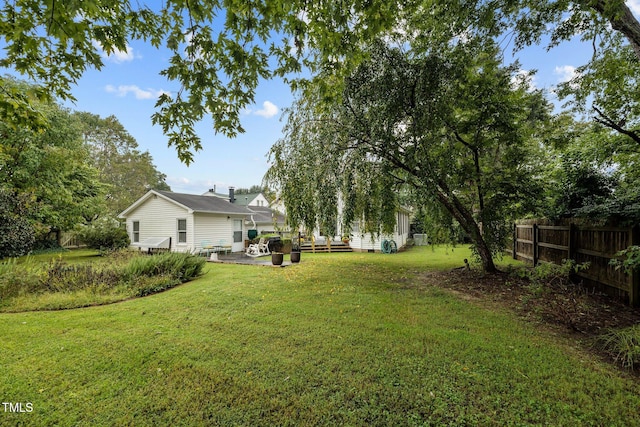 view of yard with a deck and a patio