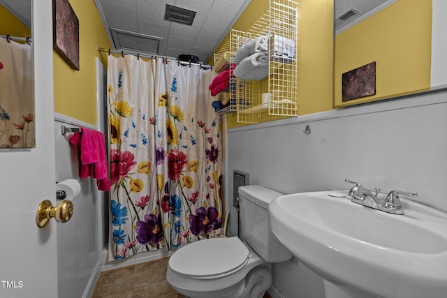 bathroom with tile patterned flooring, a shower with shower curtain, toilet, and sink