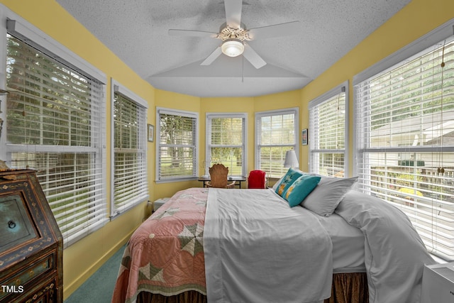 bedroom with carpet flooring, ceiling fan, and a textured ceiling