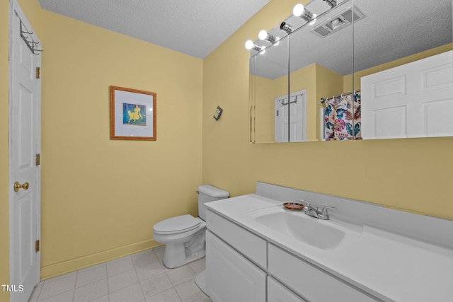 bathroom with a shower with curtain, tile patterned flooring, a textured ceiling, toilet, and vanity