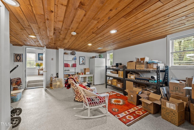 interior space featuring a wealth of natural light, wooden ceiling, and white refrigerator