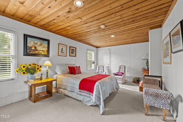 carpeted bedroom featuring wood ceiling and ornamental molding